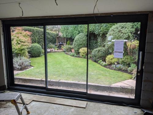 Dining room designer slim profile sliding doors onto garden